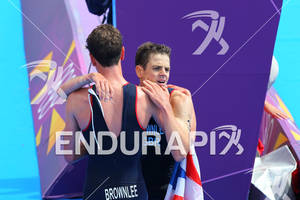 Gold medalist Alistair BROWNLEE (GBR) and his brother Jonathan BROWNLEE (GBR) the Bronze medals, exhausted after the finish at the 2012 London Olympics Men's Triathlon.