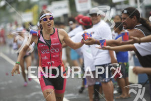 Pro athletes refresh at an aid station during the 2013 Ironman World Championship in Kailua-Kona, Hawaii on October 12, 2013.