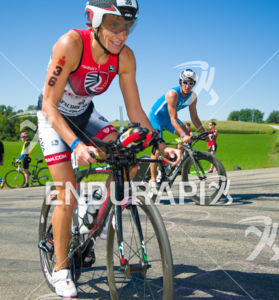 2nd place finisher Tamara Kozulina cycles past age groupers  at the Ironman Wisconsin 2014 event in Madison, WI.
