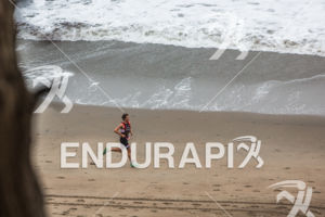 Josh Amberger runs along Baker Beach in first place at the 35th Annual Escape from Alcatraz Triathlon on June 7, 2015 in San Francisco, CA