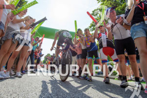 Age group athlete is cheered by spectators at Solar Hill during the bike leg of Challenge Roth in Roth, Germany on July 12, 2015