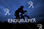Silhouette of an athlete on the bike at the Ironman…