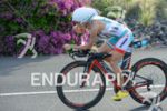 Mirinda Carfrae (AUS) eats a gel on the bike portion…